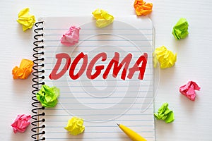 Dogma word written on notebook photo