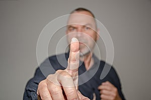 Dogmatic or authoritative man holding up a finger