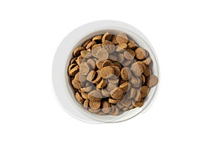 Dogs or cats dry food in a white bowl isolated on white background, top view