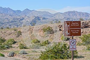 Dogs Must be on a leash and pick up after your pet sign. No fireworks sign at Lake Mead National Recreation Area in Mohave county,