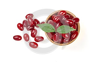 Dogwood berry with leaf in a wooden bowl isolated on white background. Top view