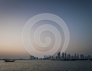 Doha city urban skyline view and dhow boat in qatar