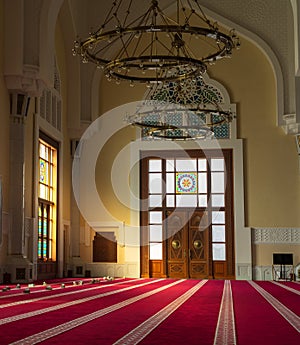 Sun light coming through the colorful stained glass window of a mosque