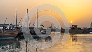 Doha, Qatar- Multiple wooden fishing dhows docked in the doha corniche