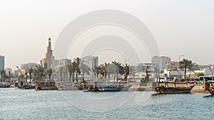 Doha, Qatar- Multiple wooden fishing dhows docked in the doha corniche