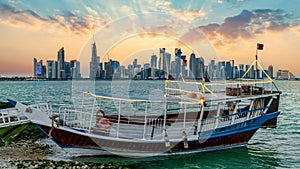 Doha Qatar skyline with traditional Qatari Dhow boat in the harbor, Qatar