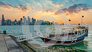 Doha Qatar skyline with traditional Qatari Dhow boat in the harbor, Qatar