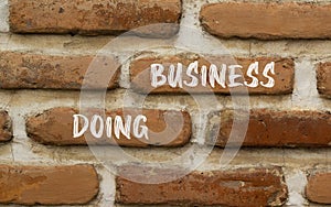 Doing business symbol. Concept words Doing business on beautiful brown bricks. Beautiful brick wall background. Beautiful brick