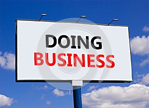 Doing business symbol. Concept words Doing business on beautiful big white billboard. Beautiful blue sky cloud background.