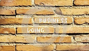 Doing business symbol. Concept words Doing business on beautiful brown bricks. Beautiful brick wall background. Beautiful brick