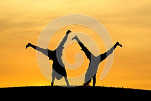 Doing cartwheels together.