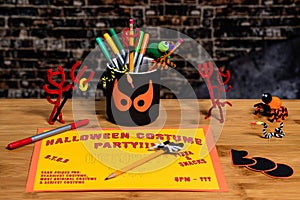 Doing crafts and Making a Party Sign for Halloween.  Several Halloween Craft decorations are also in the shot.  Negative Space for