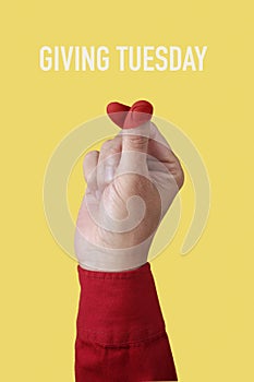 doing finger heart gesture and text giving tuesday