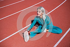 Doing her best. health and energy. stretching and warming up. lady in fitness sportswear has pumped body. training and