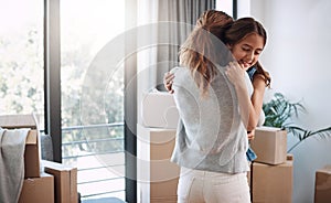 Doing it for her daughter. an attractive young woman and her daughter dancing while moving into their new home.