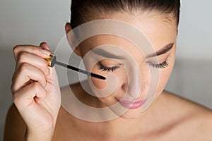 Doing Makeup. Woman Applying Mascara on Eyelashes