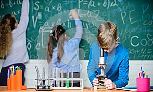 Doing research. Little kids learning chemistry in school lab. Little children at laboratory. Chemistry microscope