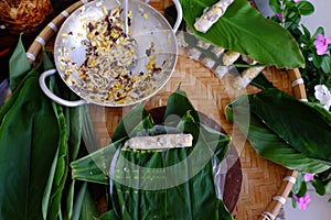 Doing Vietnamese vegetarian dish, make deep fried corn  spring roll, vegan food in leaf background