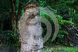 Dol Hareubang statue in green forest, Seogwipo, Jeju Island, South Korea