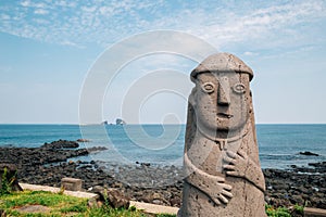 Dol hareubang stone grandpa sculpture and sea, Jeju Olle Trail in Jeju Island, Korea