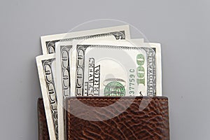 dolars in wallet on gray background