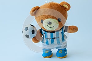 Doll bear play football