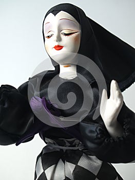 Doll in black habit giving blessing