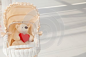 Doll buggy vintage with teddy bear and red heart