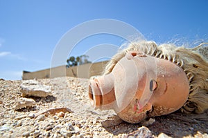 Doll head lying on the ground