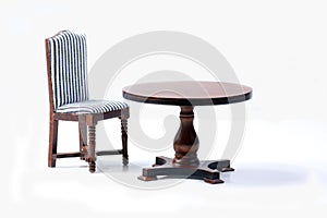 Doll house interior - chair and a table isolated on white background