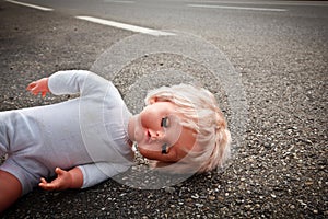 Doll leave on a highway lane