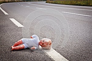 Doll leave on a highway lane