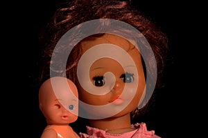 Doll portrait on a black background.