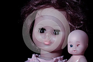 Doll portrait on a black background.