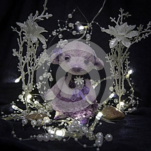 Doll of a purple bear-girl with pearls ornaments