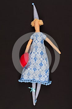 Doll with red bag