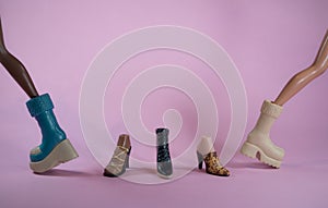 Doll shoes with two dolls walking on pink background