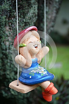 Doll on swing