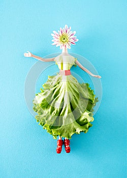 A doll whose dress is made of Batavia salad, and whose head is a Margarita flower