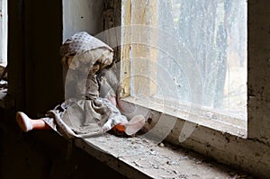 Doll on windowsill in abandoned kindergarten in destroyed village of Kopachi, Chernobyl Exclusion Zone, Ukraine