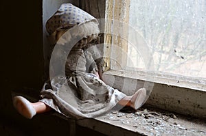 Doll on windowsill in abandoned kindergarten in destroyed village of Kopachi Chernobyl NPP alienation zone, Ukraine