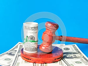 Dollar bank notes and gavel. Fine or penalty violation of laws.