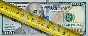 100 dollar banknote with yellow ruller