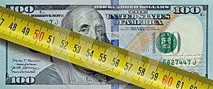 100 dollar banknote with yellow ruller