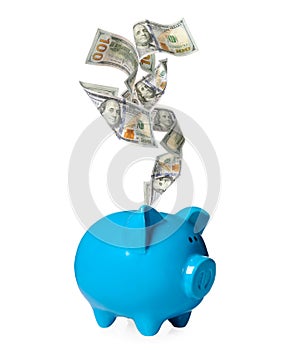 Dollar banknotes falling into blue piggy bank on white background