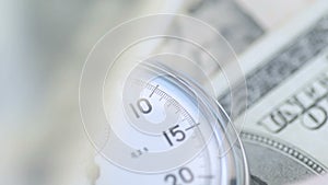 Dollar banknotes flying over the stopwatch dial