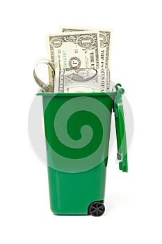 Dollar banknotes in green wheelie bin photo