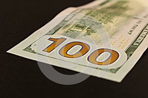 100 dollar bill. Isolated on black background. Selective focus