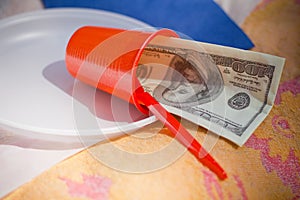 Dollar bill in red plastic cup