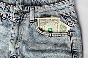 A dollar bill sticking out of a pocket of blue jeans, a credit card, and a wallet. Poverty and unemployment.